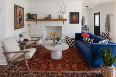 a living room filled with furniture and a fire place under a painting on the wall