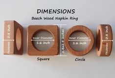 three wooden rings with measurements for them on a white surface, including the size and width