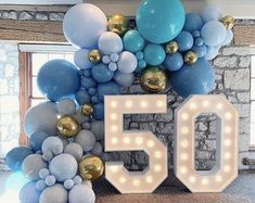 a large number 50 sign surrounded by balloons