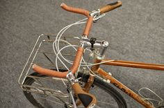 the handlebars and bars on this bicycle are made out of wood or metal