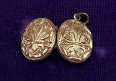 An ornate Victorian pinchbeck locket pendant with beautiful Repousse 'Fleur-De-Lis' *style design on the front and reverse.  This locket is very old but in very good vintage condition. This would make an ideal present for someone who has an interest in antique vintage jewelry. The clasp opens and shuts perfectly. The locket comes in a decorative pouch with matching ribbon bow.  Description - Lenght - 2.5 cm  Width - 2 cm Good vintage condition with light marks appertaining to age and usage! All Ornate Locket Necklace For Formal Occasions, Ornate Vintage Locket Necklace For Formal Occasions, Victorian Pendant Locket Necklace For Formal Occasions, Formal Victorian Hallmarked Locket Necklace, Victorian Medallion Jewelry With Historical Design, Victorian Locket Necklace With Intricate Design For Formal Events, Victorian Locket Necklace With Intricate Design For Formal Occasions, Victorian Medallion With Historical Design Jewelry, Historical Collectible Locket Jewelry