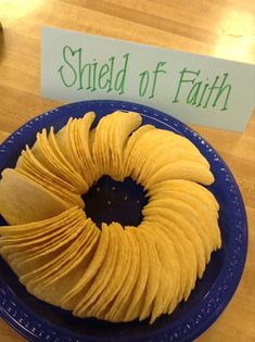 a blue plate topped with sliced bananas on top of a wooden table next to a sign