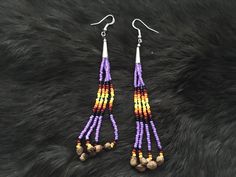 Authentic Beautiful Native American Indian Jewelry Navajo Hand Beaded Long Dangle Earrings with "Ghost Beads" Great for a gift❤️ Handcrafted by Navajo Artist R. Sellers These beautiful earrings are 4.75" in length and 1" in width. Ghost Beads Represent interconnection with the earth, trees, animals and humans. Wear it to bring about peace, harmony and safety. It wards off negative energy, bringing about protection from evil spirits, ghosts and nightmares. Give them as gifts or buy for yourself! Southwestern Dangling Beads For Jewelry Making, Southwestern Dangle Beaded Earrings For Festivals, Southwestern Style Dangle Beaded Earrings For Festivals, Southwestern Style Beaded Dangle Earrings For Festival, Southwestern Style Festival Beads With Dangling Details, Traditional Purple Beaded Earrings For Festivals, Southwestern Adjustable Beaded Fringe Earrings, Southwestern Beaded Fringe Dangle Jewelry, Southwestern Style Earrings With Round Beads For Festivals