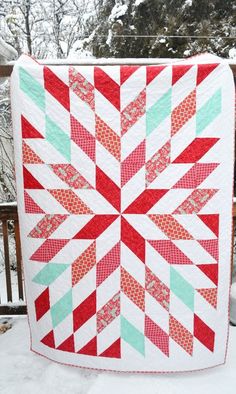 a red, white and green quilt with text overlay that reads half square triangle star quilt