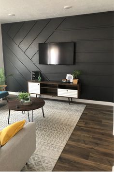 a living room with two couches and a television on the wall in it's center