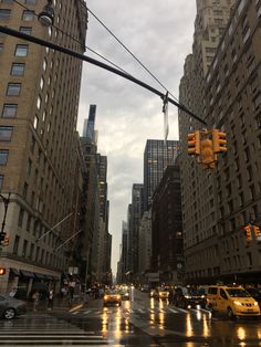 a city street filled with traffic and tall buildings