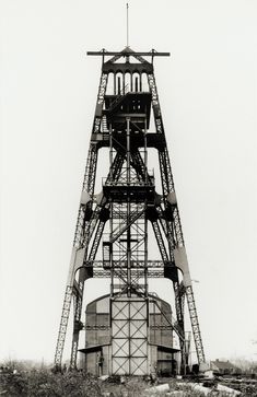 an old black and white photo of a tower