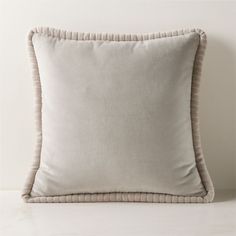 a white pillow with ruffled edges on a table