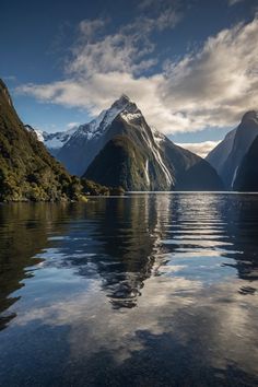 the mountains are reflected in the still water