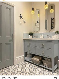 a bathroom with two mirrors, a sink and a rug on the floor in front of it