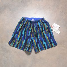 "Great pair of vintage swim shorts by Speedo. Drawstring waist. Fully lined. Excellent vintage condition - like new with tags. Please see actual measurements below.  Waist: 38-42\" Inseam: 6\" Outseam: 16\" If you would like to see additional photos or have any other questions, please do not hesitate to ask, and thanks for looking! Shipping disclaimer: All domestic orders under 16oz ship USPS Ground Advantage. All domestic orders over 16oz ship USPS priority mail. All international orders under Retro Blue Bottoms For Poolside, Retro Blue Swimming Bottoms, Retro Blue Swim Bottoms, Vintage Athletic Shorts For Summer, Vintage Summer Athletic Shorts, Retro Swim Trunks With Built-in Shorts For Beach, Vintage Blue Swimwear For Swimming, Vintage Blue Swimwear For The Beach, Retro Blue Bottoms For Beach Season