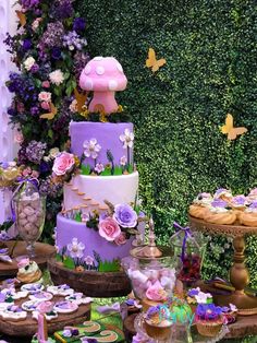 a table topped with lots of cakes and cupcakes