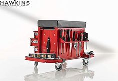 a red wagon with tools in it on a white surface