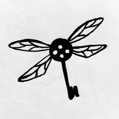 a metal clock with a dragonfly design on it's face is shown in the shape of a key