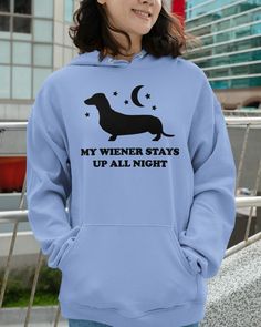 a woman wearing a blue hoodie that says, my wiener stays up all night