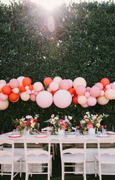 a long table with balloons and plates on it