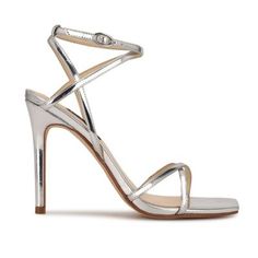 The strappy Tidle ankle strap sandal is an ultra sexy update to an essential dress shoe. The sky high stiletto heel is paired with a modern square toe and multiple criss-crossed skinny straps. Founded in 1978, Nine West empowers women to take on the world in style, from day to night. | Nine West Women's Tidle Ankle Strap Dress Sandals, Silver, 10M Essential Dress, Dress Shoe, Modern Square, List Style, Sky High, Dress Sandals, Strap Dress, Ankle Strap Sandals, Stiletto Heel