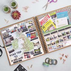 an open travel planner on a table with scissors and other things to do around it