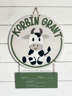 a sign that is on the side of a building with a cow painted on it