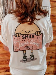 Smile, Jesus Loves You! Help spread God's love with this cute t-shirt! Gildan, Unisex fit, recommend sizing up for an oversized fit. Color is Neutral. Cute Everyday T-shirt With Screen Print, Cute Relaxed Fit T-shirt With Text Print, Cute Everyday T-shirt With Slogan, Cute Slogan T-shirt For Everyday, Cute Funny Print T-shirt For Everyday, Cute Relaxed Fit T-shirt With Funny Print, Brown Cotton Graphic Design T-shirt, I Love Jesus Shirt, Beige Cotton T-shirt With Text Print