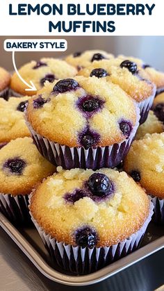 blueberry muffins on a metal tray with the words lemon blueberry muffins above them