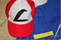 a red and white baseball cap sitting on top of a blue jacket next to a yellow tag