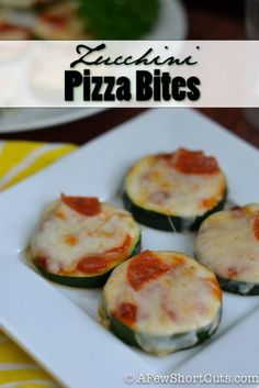 four zucchini pizza bites on a white plate with yellow and green table cloth