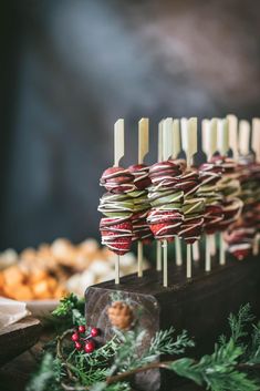 an assortment of appetizers are displayed on sticks