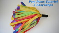 an umbrella made out of colored paper on top of a white surface with the words pom poms