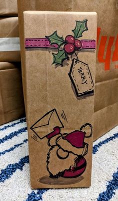 a brown paper bag with an image of santa claus on it and a tag hanging from the side