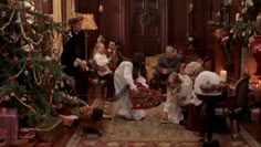 a group of people standing around a christmas tree