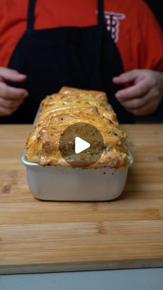 a person standing in front of a casserole dish