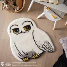 an owl rug is on the floor next to a teddy bear