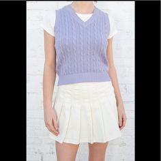 Classic Cable-Knit Sweater Vest With A High V-Neck. Fabrics: 100% Cotton Measurements: 19" (48 Cm) Length, 16" (41 Cm) Bust Made In: Italy Preppy Fitted V-neck Top, Preppy V-neck Tops For Fall, Classic White V-neck Knit Top, Fitted Knit V-neck Sweater Casual Style, Casual Fitted Knit V-neck Sweater, Fitted V-neck Cable Knit Top, Cotton V-neck Sweater Vest For Fall, Preppy V-neck Tops For Spring, Casual Fitted Cotton V-neck Sweater