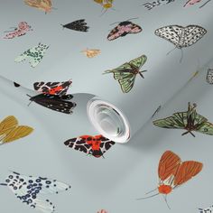 a white wallpaper with colorful butterflies on it's sides and the bottom half of the wall