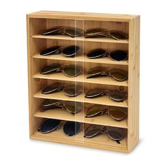 a wooden display case with many pairs of sunglasses on it's sides and two rows of glasses in the middle