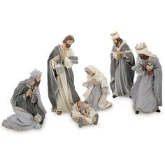 the nativity figurines are all dressed in grey and white