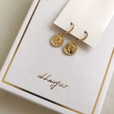 Dainty gold dangle coin earrings. These gold huggie earrings feature a tiny Italian lira coin charm. Delicate and yet eye catching. The ultimate accessory for every outfit, day to night. made of 14k gold plating over brass.Measurements:Diameter- 10mmCoin charm- 12xmm Shipping:Please allow 1-3 business days for your order to be processed and shipped. All orders are shipped in our customize box, gift ready. *Let me know if you have any questions and I will promptly respond Gold Drop Earrings With Charms, 14k Gold Filled Charms Drop Earrings, 14k Gold Filled Drop Earrings With Charms, Gold Coin Pendant Earrings, Everyday Gold Plated Charm Earrings, Minimalist 14k Gold-filled Charm Earrings, Minimalist 14k Gold Filled Charm Earrings, Minimalist Charm Earrings For Gifts, Minimalist Gold Plated Earrings With Charms