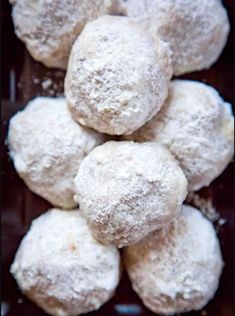 a pile of powdered sugar cookies sitting on top of a table