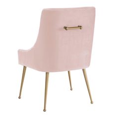 a pink velvet chair with gold legs and a button on the armrest that is attached to