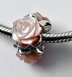 Fits on Pandora and European charm bracelet  very well handcrafted  925 sterling silver and Natural pink Mother of Pearl Roses 925 stamped Length 15mm Pink Natural MOP Rose 8mmX3 Hole 4.5mm Silver Flower Charms For Gifts, Elegant Rose Gold Sterling Silver Charms, Pink Sterling Silver Charm Bracelet For Anniversary, Pink Pearl Charm Jewelry For Valentine's Day, Elegant Sterling Silver Charms For Mother's Day, Elegant Pink Charm Bracelet, Valentine's Day Pink Jewelry With Pearl Charm, Valentine's Day Pink Pearl Charm Jewelry, Pink Sterling Silver Charms