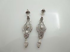 "For Sale: (1) g650 Stunning Vintage Pair of 14kt White Gold Filigree and Diamond Dangle Earrings PLEASE READ ENTIRE DESCRIPTION BEFORE PURCHASING These are a pretty pair of marquise diamond earrings. Each earring is set in 14kt white gold and features a filigree design and .05ct marquise diamond in each center. For added flair, they also have a dangling .25ct marquise diamond as well. Perfect for an elegant night on the town. Screwback is stamped 14k. Would be a lovely birthday, Mother's Day, C Formal Silver Diamond Earrings With Intricate Design, Silver Diamond Earrings With Intricate Design For Formal, Silver Diamond Earrings With Intricate Design For Formal Occasions, Art Deco Formal Earrings Hallmarked, Elegant Engraved Drop Earrings, Victorian Engraved Earrings For Formal Occasions, Ornate Drop Diamond Earrings For Formal Events, Ornate Drop Diamond Earrings For Formal Occasions, Ornate Diamond Drop Earrings For Formal Occasions