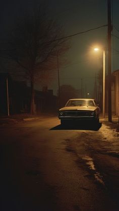 a car parked on the side of a road at night