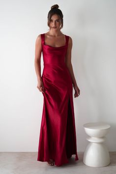 This gown is your perfect choice for debs, prom or any formal event. A look that blends classic glamour with contemporary style. Designed for timeless allure and effortless sophistication. Featuring a graceful cowl neckline and thick shoulder straps, this dress offers a flattering, structured fit. The sultry thigh-high slit adds a bold, modern touch, while the luxurious satin fabric drapes beautifully to enhance your silhouette. Highlights Stunning red gown with cowl neckline Soft satin material Long Satin Dress Pink, Sheath Floor Length Dress, Floor Length V Neck Red Dress, Red Bridesmaid Dresses Sposadresses, Crimson Bridesmaid Dresses Silk, Long Red Dress Formal Bridesmaid, Red Long Dress Formal Nordstrom, Elegant Long Dresses Red, Deep Red Formal Dress Long