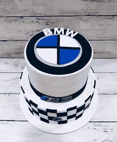 a three tiered cake with the bmw logo painted on it's front and side