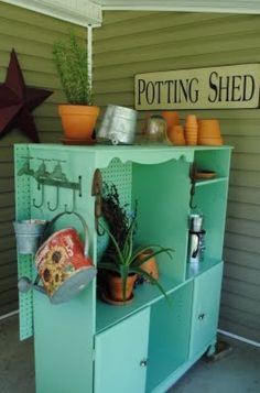 an outdoor potting shed with pots and plants on the top shelf next to it