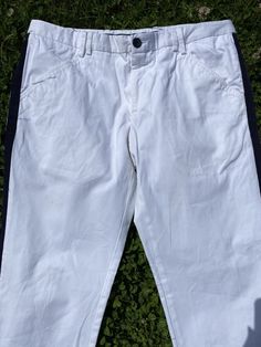 Magnificent Classic Trousers Design Dolce Gabbana, Italy 90s. White trousers with a blue side stripe in cotton. Two front pockets and three back pockets, straight leg model at the ankle, button closure and zipper. Hardware all signed. Stylish and elegant. Excellent condition. Our products can be used immediately without any problem, there is no dust, smell or anything like that. All the products in our store are 100% original and authentic. The product that will be shipped is exactly what you se White Wide Leg Bottoms With Hip Pockets, White Bottoms With Hip Pockets For Spring, Casual White Chinos For Summer, White Casual Summer Chinos, White Cotton Pants For Spring, Fitted White Bottoms With Hip Pockets, Spring White Chinos With Pockets, White Spring Chinos, Spring White Chinos