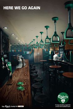 there is a bar with lots of bottles on the counter and stools in front of it