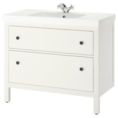 a white bathroom vanity with two drawers and a faucet on the sink side