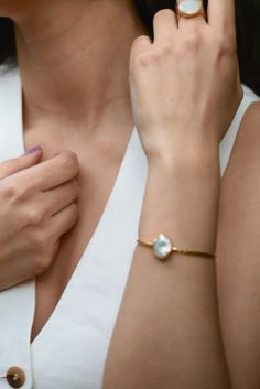 This freshwater pearl cuff bracelet is made of 22k gold-plating on brass. In this natural white pearl cuff , beautiful coin shaped freshwater pearl is used and nestled inside the carefully crafted oval. You can enjoy wearing this minimalist bracelet every day or on special occasions with great pleasure. This adjustable bracelet features a practical design that can be easily fit your wrist comfortably. Dainty Pearl Bracelet, Minimalist Bangle, Pearl Cuff Bracelet, Pearl Jewelry Design, Pearl Cuff, Cuff Bracelets Handmade, Bracelet Minimalist, Bridesmaid Bracelet, Minimalist Bracelet